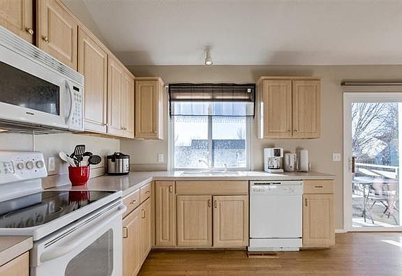 Spacious Kitchen with Microwave, Oven, Dishwasher and Disposal! Natural Wood Flooring, Cathedral Ceilings!