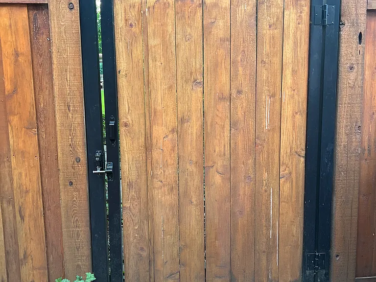 Rear Man Gate is positioned for easy access to both Recycling Bins and regular Garbage cans, to enter Alley behind property