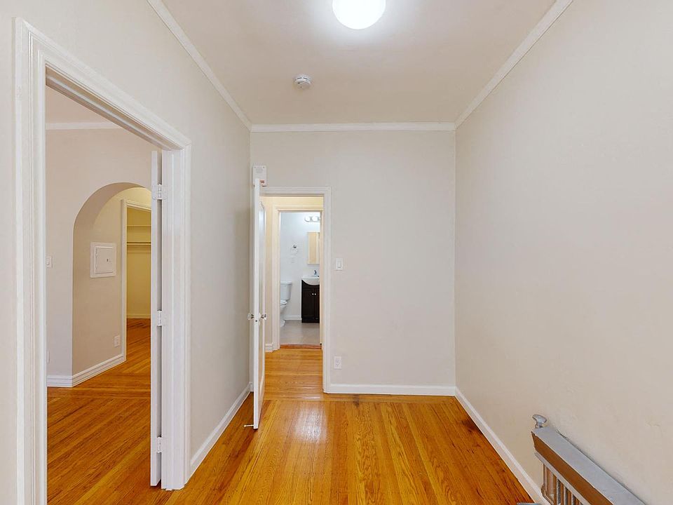 Bedroom with a window and a wood-like floors