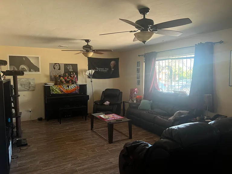 3 bedroom unit living room. Leather couches, TV etc, come furnished.