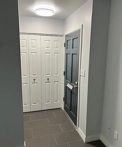 Living Room: Front Door Entry Way, Entry Way Light, Front Entry Closet, Tile and Grout Flooring, Freshly Painted Ceiling, Walls, Baseboards, Doors and Moldings.