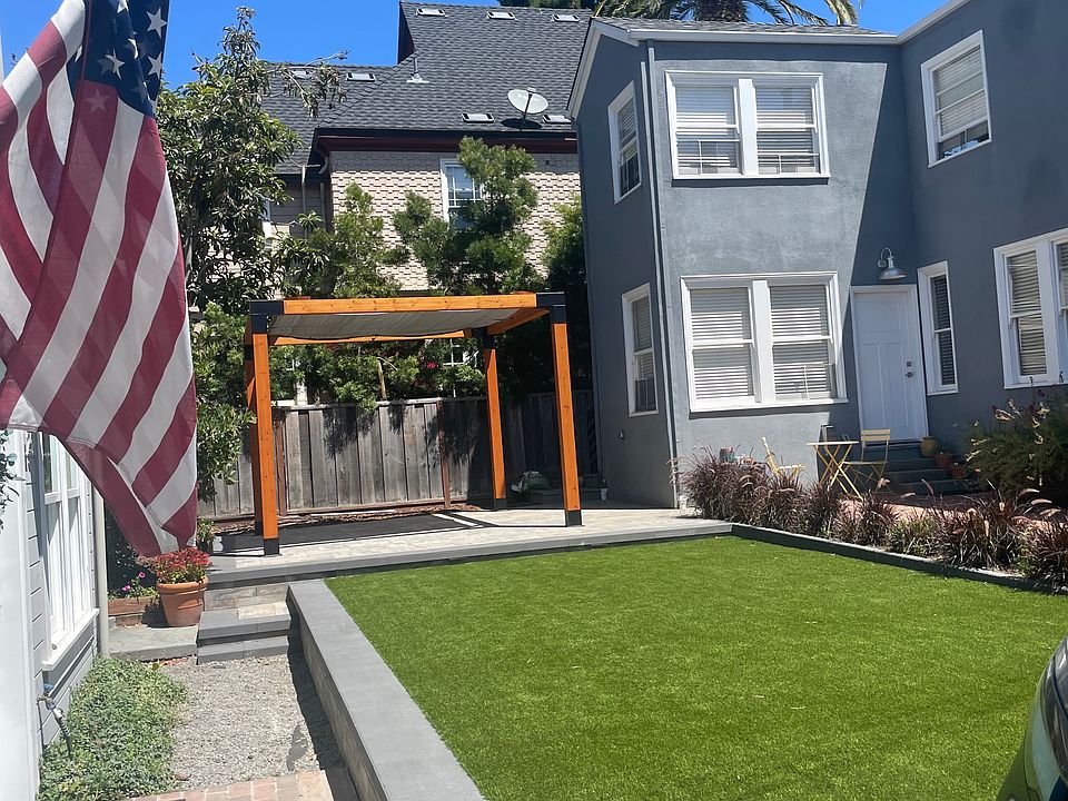New landscaping in the courtyard separating the front building and the carriage house. Turf, pavers and shaded pergola area.
