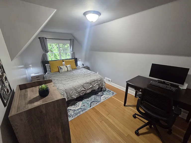 This bedroom suite features a convenient desk and workspace