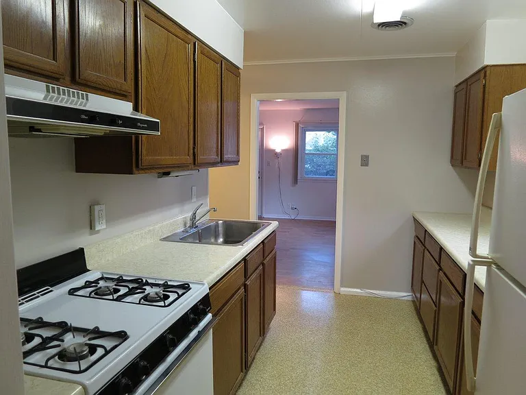 Galley kitchen featuring a gas stove.