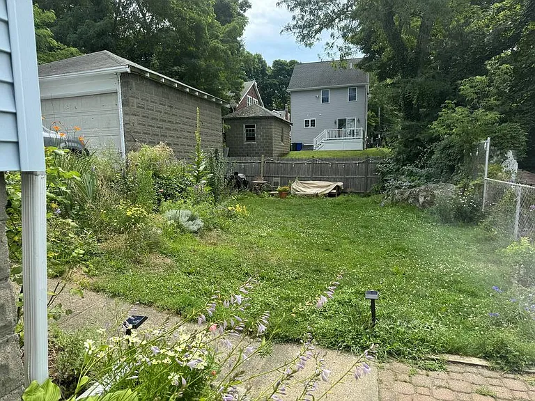 Walk through the gate, down the path, and gaze upon the beautiful backyard. So many flowers in bloom!