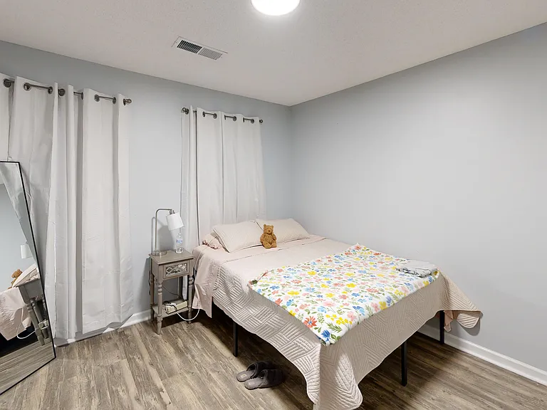 Bedroom two with reach-in closet. Photo is of a similar unit; available unit has the same floorplan. Furniture and decor not included.