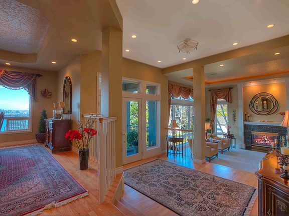 Beneath high ceilings, past the main entrance is the large, gracious living room with gas fireplace.