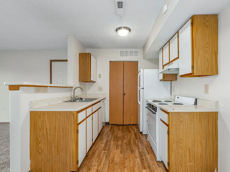 Kitchen of a River Valley apartment home in Lancaster, OH, with cabinets, stove, oven, refrigerator.