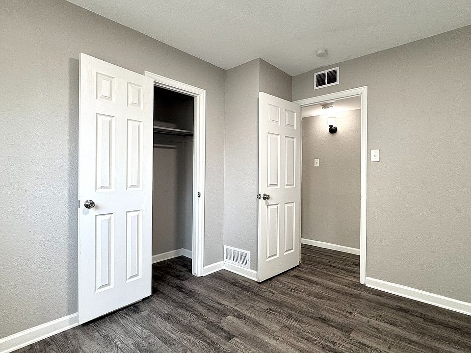 Bright and inviting room with elegant wood flooring, fresh paint, and ample closet space, perfect for modern living.