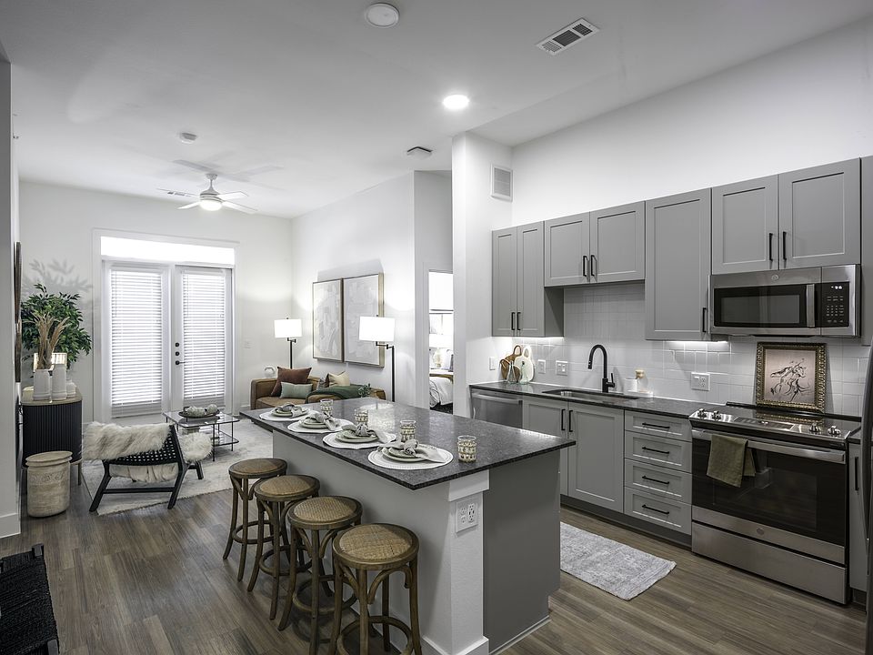 Upgrade your culinary space with stunning granite countertops and a spacious kitchen island, perfect for both style and functionality.