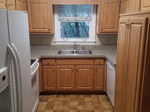 Kitchen with dishwasher, stove, refrigerator, and microwave.