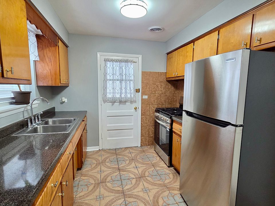 KITCHEN WITH NEW STAINLESS STELL STOVE AND FRIDGE