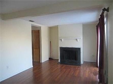 Family room with fireplace and wood floor
