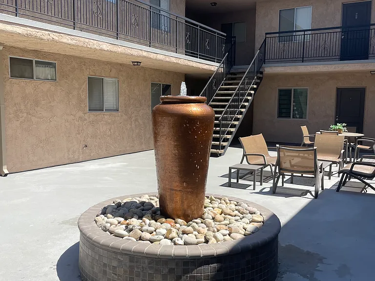 Beautiful copper fountain with patio furniture