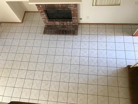 living room with fireplace looking down from upstairs