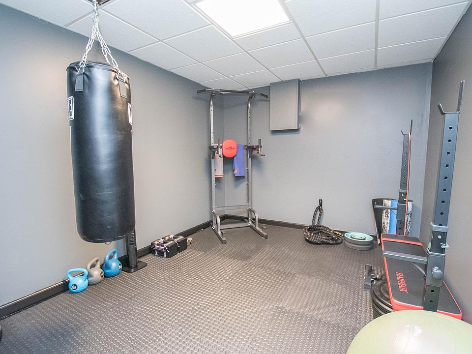 Private gym with padded flooring, Olympic sized bar and plates as well as power tower, battle ropes, kettle bells, dumbbell tower, yoga mat and professional punching bag.