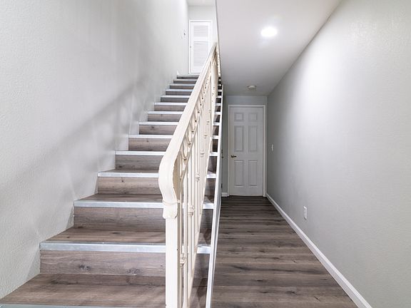 Hallway to first floor bedroom & stairs to 2nd level.