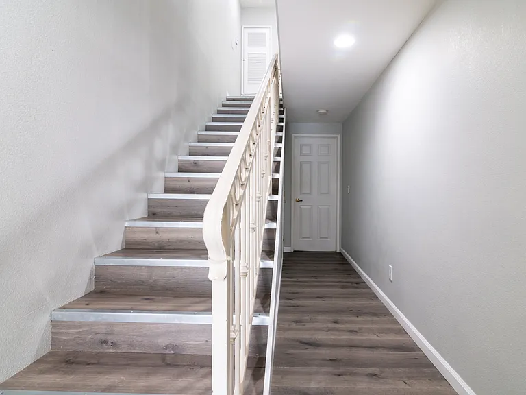 Hallway to first floor bedroom & stairs to 2nd level.