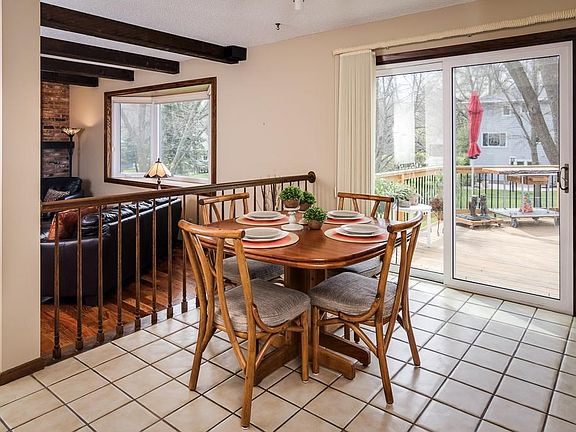 Informal dining area with access to the multi-level deck and large backyard space.