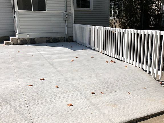 Parking pad with fence