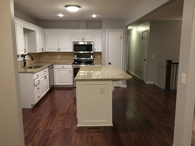 Stainless Steel Appliances throughout Older Picture showing the kitchen before the floors were redone.