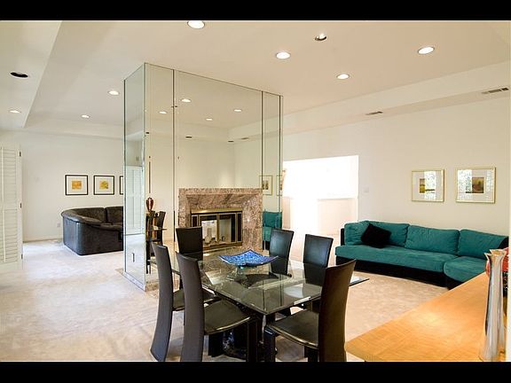 The greatroom includes high ceilings & a double-sided fireplace