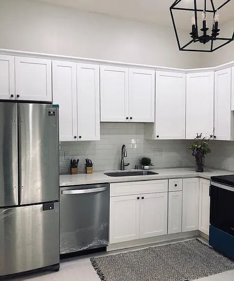 Beautiful 10 foot ceiling, bright, spacious, eat in kitchen with white maple shaker cabinets, white subway tile backsplash, quartz counter, stainless steel appliances, tile floors