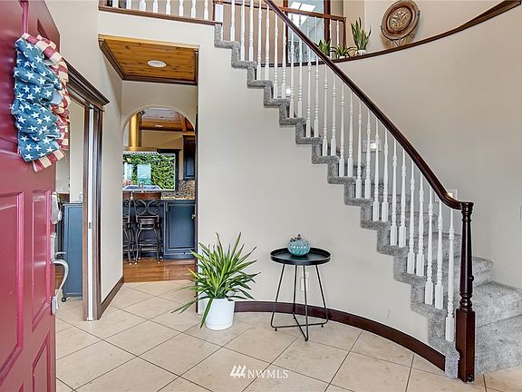 Welcome to a curved staircase and arched doorways