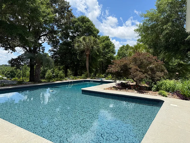 Surrounded by palm trees, oak trees, and a Japanese maple that brings new beauty each season.