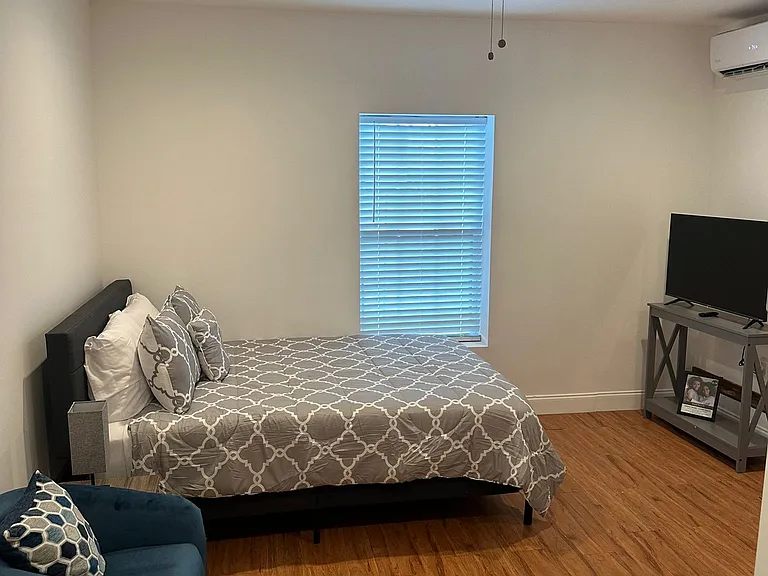 Equipped with a ceiling fan and two nightstands with lamps for added comfort.
