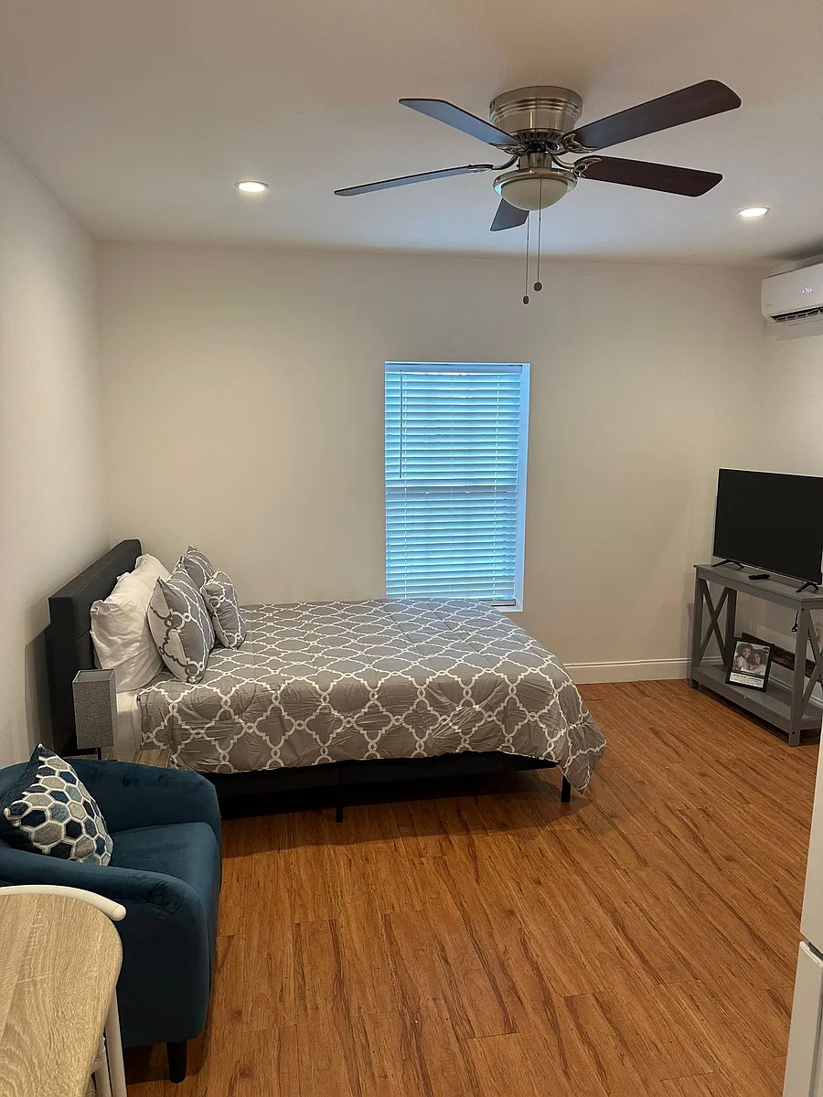 Equipped with a ceiling fan and two nightstands with lamps for added comfort. - 4819 Old Harden Blvd #1