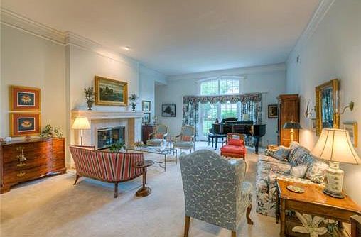 Spacious formal living room  with limestone fireplace.