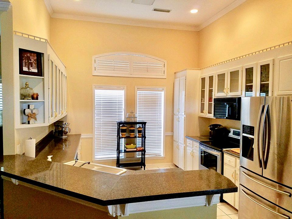 Kitchen with wrap around counter is off from separate laundry room with sink.( Refrigerator not included)