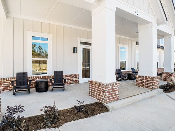 Clubhouse exterior porch with rocking chairs to relax and unwind.