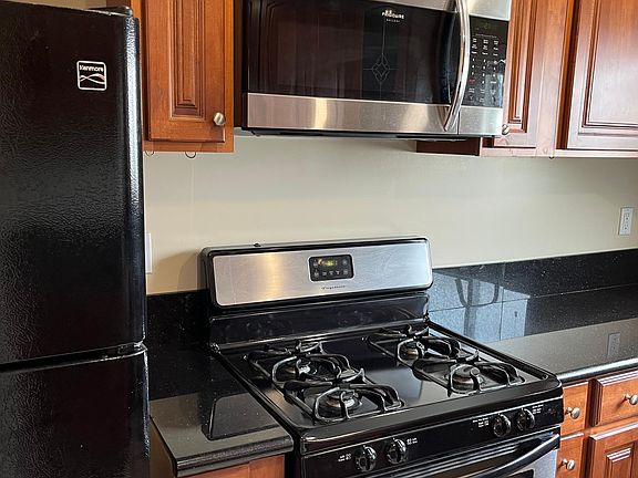 Kitchen- Stove and oven and microwave and refrigerator