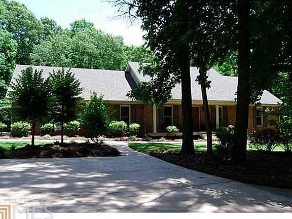 Lush well manicured landscape along with private wooded lot surround this lovely home!