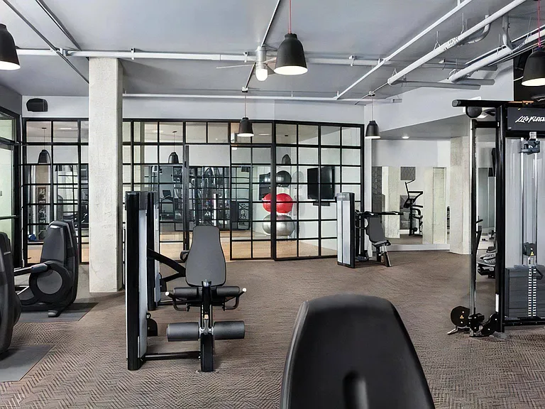 Apartment Fitness Area with Weight Machines and Studio Room