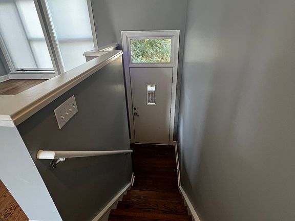 View from main stairs landing to front door