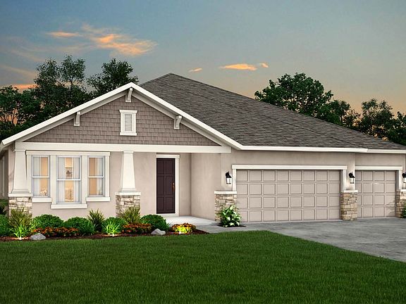 Sapphire new home exterior elevation craftsman with stone at dusk William Ryan Homes Tampa