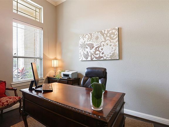 Conveniently located off of the inviting entry is the home office. Perfect vantage point to see the front of the home and be aware of all your home deliveries.