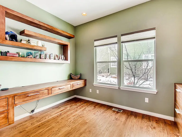 Office with custom built in desk and shelves
