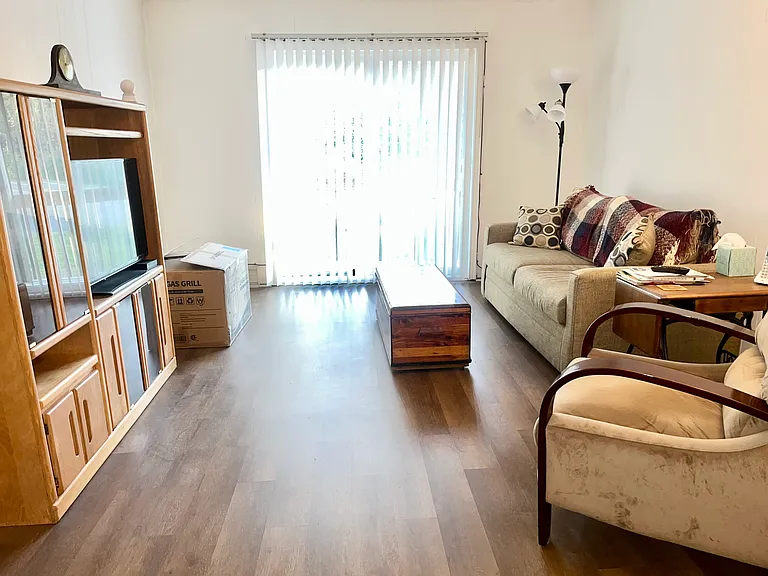 Living room with sliding door to private balcony.