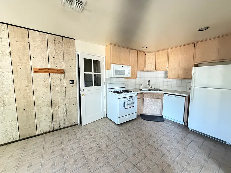 Kitchen area with access to laundry room/storage area.