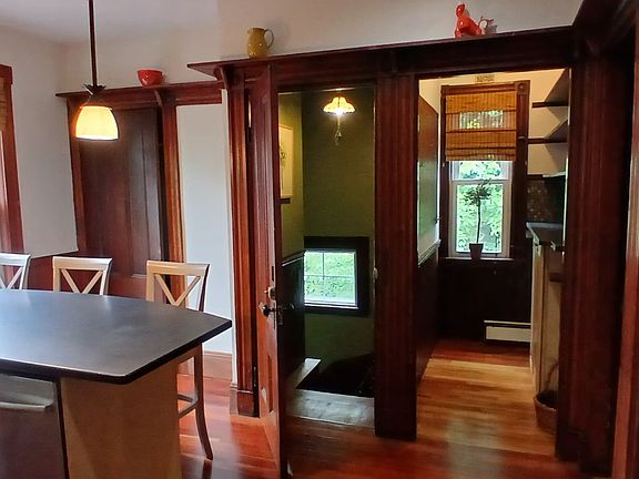 Kitchen looking towards pantry which offers additional storage. Left side of kitchen has laundry area, stackable Maytag 'Neptune' washer & dryer with additional storage.