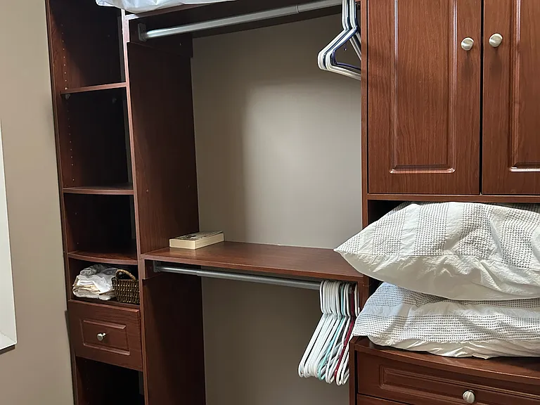 Walk-in closet with built-in shelving and organized space.