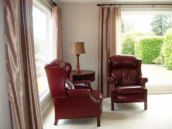 Living room with floor to ceiling windows make this room bright and inviting