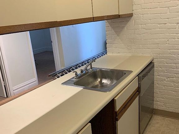 Kitchen sink, dishwasher, and cabinets