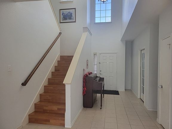 Front door with steps leading upstairs
