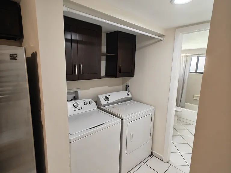 laundry nook with storage cabinets