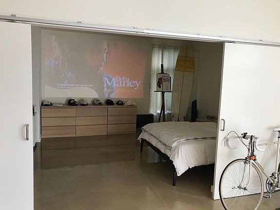 Bedroom with sliding door. Great set up for projector!